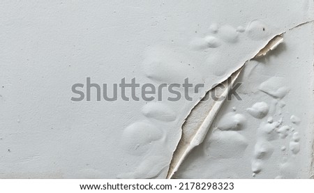 Problem of moisture damage acrylic white painting crack surface texture on exterior dirty stain concrete structure wall background by humidity.home repair old construction concept,renovation house.  Royalty-Free Stock Photo #2178298323