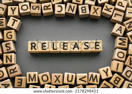 Inscription Release software development concept. Wooden cubes with letters scattered blurred background
