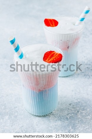 Summer strawberry matcha latte with ice in a glass cup