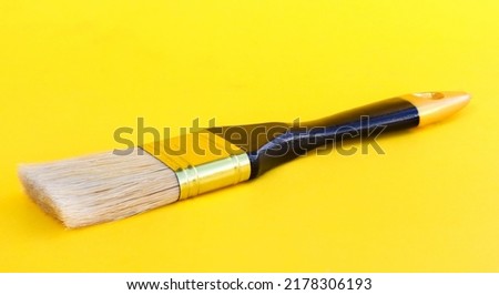 paint brush on yellow background
