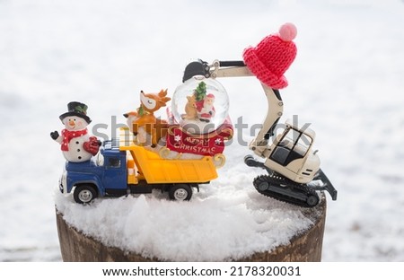 miniature souvenir figurines and toy construction equipment in a composition on the theme of Christmas greetings for the construction business