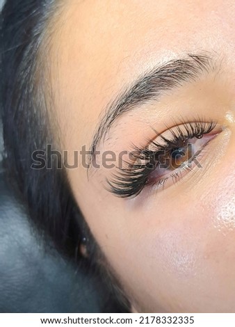 Lash extensions in beauty salon macro eye top view 