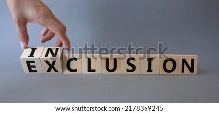 Inclusion and Exclusion symbol. Business,man hand. Turned wooden cubes with words Inclusion and Exclusion. Beautiful grey background. Business and Inclusion and Exclusion concept. Copy space Royalty-Free Stock Photo #2178369245