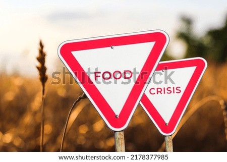 Food crisis concept. Two red road signs. Defocus blank empty triangle red warning road sign on nature background. Hunger problem. Human disaster. Economy. World crisis, war. Out of focus.