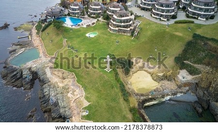 Aerial photography from a drone. View of the hotels on the rocks by the sea with swimming pools and green lawns. Sozopol, Bulgaria