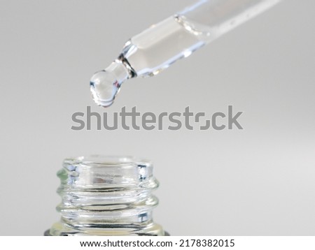 Oil for skin care is dripping with a pipette. Close-up. Royalty-Free Stock Photo #2178382015