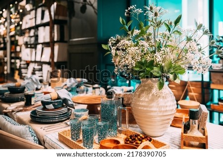 View of assortment of decor for interior shop in store of shopping center. Home accessories and household products for dining room in store of shopping centre. View of beautifully set table. Home Royalty-Free Stock Photo #2178390705