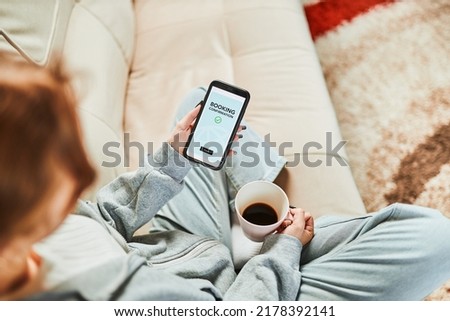 Woman booking vacation online. Person paying for hotel from home. Booking flight using mobile payment app. Purchasing service using smartphone. Online shopping from home. Order confirmation on screen Royalty-Free Stock Photo #2178392141