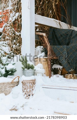 front porch of rustic country house in winter in snow, suburban area with stylish decor, atmosphere of Christmas and New year celebration background