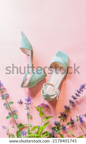 Fashion - summer footwear for woman. Pastel mint green sandals shoes and meadow flowers on bright pink background. Poster with free copy (text) space. Royalty-Free Stock Photo #2178401745