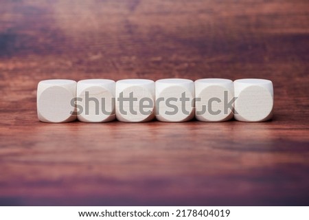 six wooden cubes in a row, free space for letters, symbols or any text