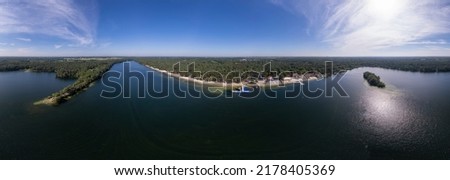 Aerial 360 degrees view of IJzeren Man lake with recreational outdoor activity sports and leisure park at the beach shore. Holidays and leisure in The Netherlands. 3D panorama ready for VR.