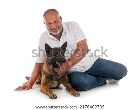 belgian shepherd and man in front of white background