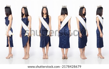 Full length body of Miss Beauty Pageant Contest wear blue evening sequin gown with diamond crown sash, Asian female stand express feeling happy smile over white background isolated Royalty-Free Stock Photo #2178428679