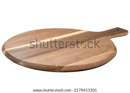Food preparation tool, pizza platter and kitchen utensil concept with close-up on disk shaped wood chopping board with round corners isolated on white at an angle perspective with clipping path cutout
