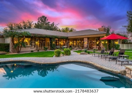a luxury pool at sunset Royalty-Free Stock Photo #2178483637