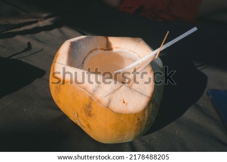 picture of fresh coconut juice on a tropical beach
