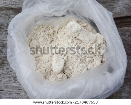 Lime in plastic bags is used as fertilizer to nourish trees planted in agricultural gardens. Royalty-Free Stock Photo #2178489653