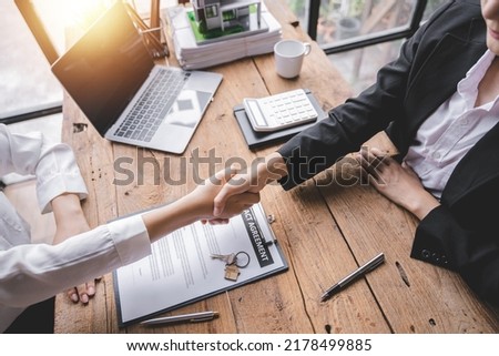 Handshake real estate agents deliver sample homes to customers. mortgage loan agreement Make a contract for hire purchase and sale of a house. and home insurance contracts home mortgage loan concept
