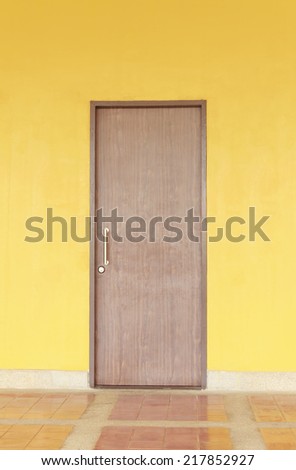 Vintage Door on yellow cement wall can be used for background