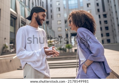 Young man and young woman flirting and looking excited Royalty-Free Stock Photo #2178549981