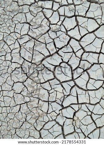 ground broken and parched by drought Royalty-Free Stock Photo #2178554331