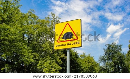 Warning Road Sign in Polish language saying 'Caution for hedgehogs'               Royalty-Free Stock Photo #2178589063