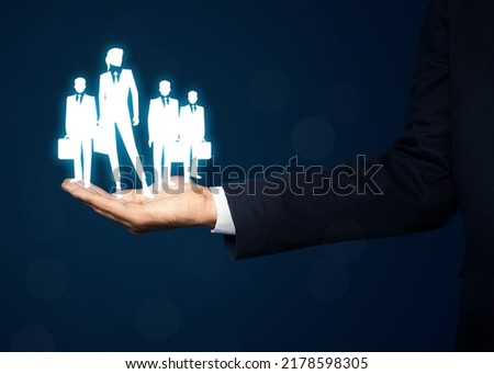 Man presenting virtual icons of businesspeople on dark blue background, closeup. Leadership concept