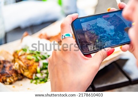 Women hand use mobile phon to take pictures of food or take live video 