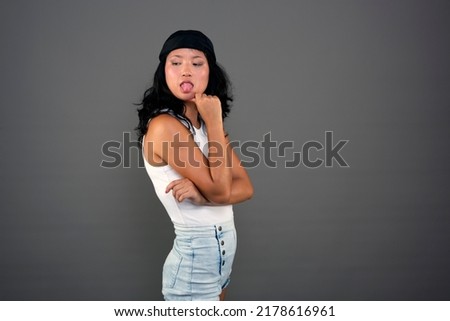 young ethnic asian woman in urban attire defiant attitude Royalty-Free Stock Photo #2178616961