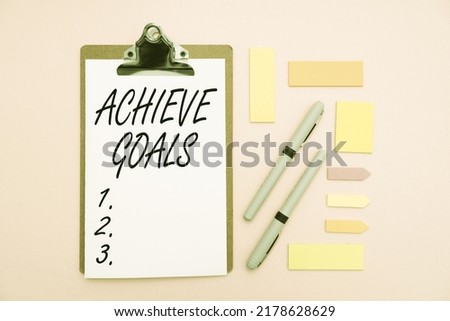 Text caption presenting Achieve Goals. Business idea Results oriented Reach Target Effective Planning Succeed Multiple Assorted Collection Office Stationery Photo Placed Over Table