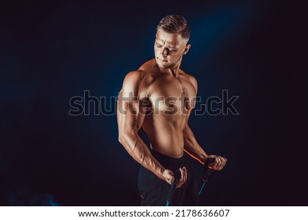 Muscular Athletic Men Exercise With Resistance Band. Copy Space.  Royalty-Free Stock Photo #2178636607