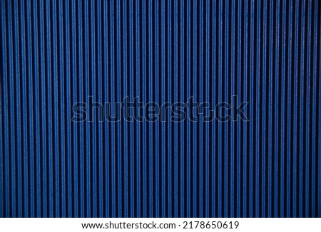 Abstract background made of corrugated paper for blue application. Space for text. Texture. Vertical stripes.