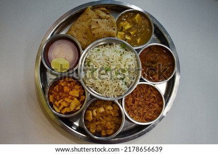 Indian food. Rajasthani Thali. Veg Full main course meal India. Maharaja Thaali. Veg Thali from an indian cuisine. Marwadi Dishes. Indian Traditional Thali Food.  Royalty-Free Stock Photo #2178656639