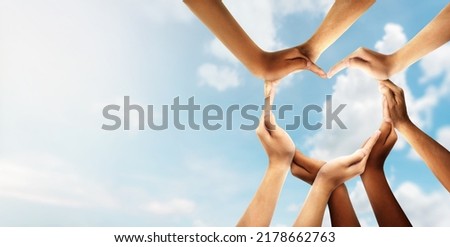 Unity and diversity are at the heart of a diverse group of people connected together as a supportive symbol that represents a sense of and togetherness. Symbol and shape created from hands. Royalty-Free Stock Photo #2178662763
