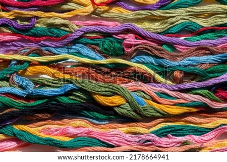 multi-colored threads for embroidery, floss, Mixed colorful texture of interlaced threads Royalty-Free Stock Photo #2178664941