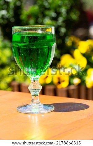 Green lemonade Tarragon in a glass glass. Green drink from healthy herbs Tarragon