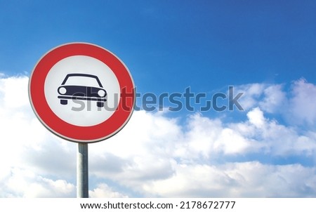 Round car sign transit prohibited for cars on a blue sky background. Car road sign, prohibition red sign. Royalty-Free Stock Photo #2178672777
