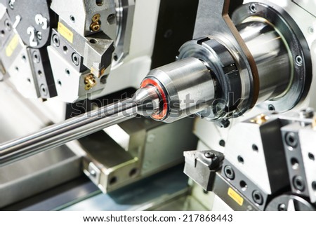shaft detail turning on metal cutting machine tool at manufacturing factory Royalty-Free Stock Photo #217868443