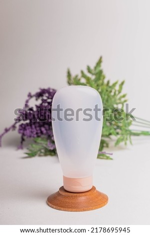 Plastic cosmetic bottle on light background.Face and body skin care with marine minerals.