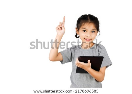 Little girl playing with a digital tablet isolated on white background.