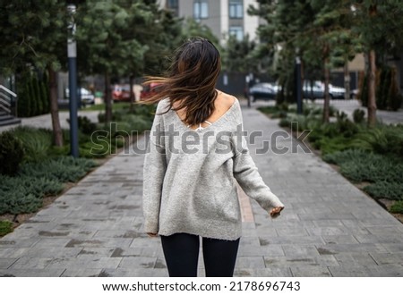 windy weather, hairs close woman's face, sad mood and cold weather. young woman on a windy day. wind blowing hair. Royalty-Free Stock Photo #2178696743