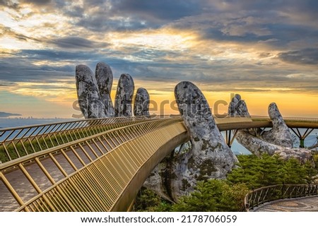Aerial view of the Golden Bridge is lifted by two giant hands in the tourist resort on Ba Na Hill in Da Nang, Vietnam. Ba Na mountain resort is a favorite destination for tourists Royalty-Free Stock Photo #2178706059