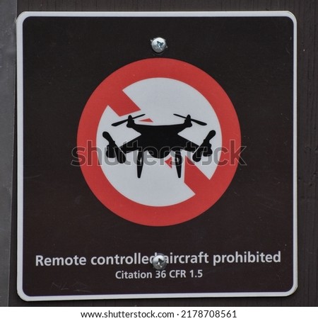 Brown and red no drones allowed sign.