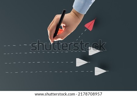 Hand draws a trace of a paper plane. Concept of ingenuity, creativity.