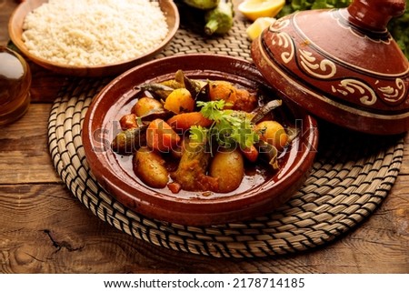 Moroccan tagine with rice served in a dish isolated on wooden background side view Royalty-Free Stock Photo #2178714185