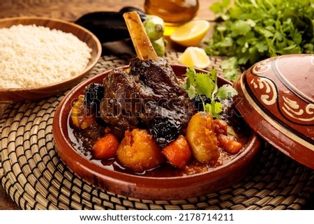Moroccan lamb and Vegetables Tangine with bread served in a dish isolated on wooden background side view Royalty-Free Stock Photo #2178714211