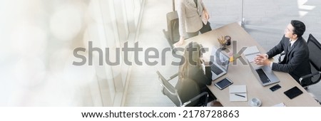 A group of young Asian businessmen Talking and planning work happily and have fun. at the company's office web banner with copy space on left