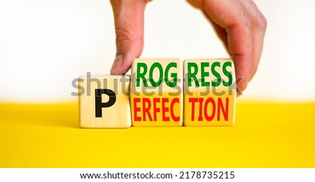 Progress or perfection symbol. Concept words Progress or Perfection on wooden cubes. Businessman hand. Beautiful yellow table white background. Business progress or perfection concept. Copy space.