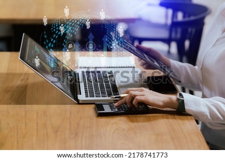 Business woman working on digital laptop and tablet with digital marketing virtual chart at table office, Business strategy and futuristic economic concept.